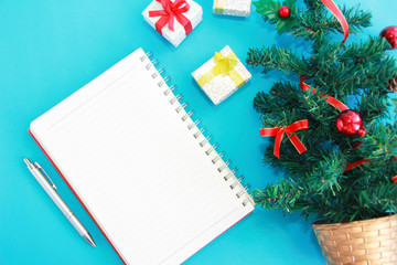 notebook for notes and a green Christmas tree with New Year's decor