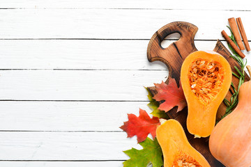 Fresh pumpkin on white wooden background. Healthy food. Top view. Free copy space.