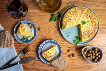 several parts of tortilla, a typical Spanish dish, with green olives