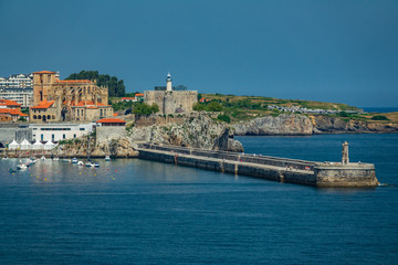 Fototapeta na wymiar Castro Urdiales breakwater and downtown with cathedral