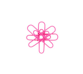 Pink paper clips in the form of a flower on white background