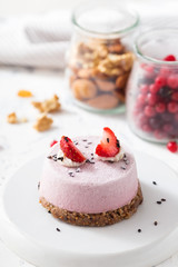 Vegan strawberry dessert. Raw cake with nuts, berries, fruits and seeds. Healthy food