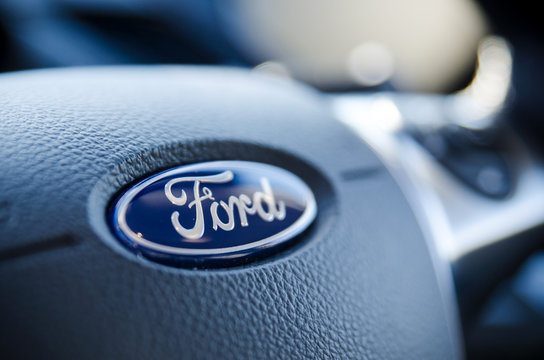 Ford sign on steering wheel close up.