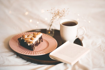 Morning coffee with piece of chocolate cafe and open book close up. Good morning. Breakfast time.