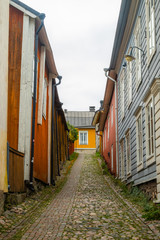 Narrow street of Old Porvoo, Finland. Beautiful city autumn landscape with colorful wooden buildings.