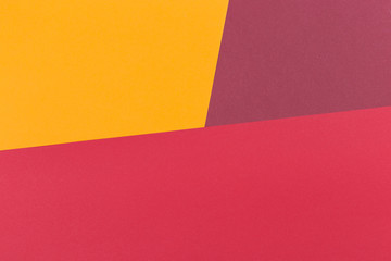 Paper yellow, burgundy, red empty background, geometrically located. Color blank for presentations, copy space.