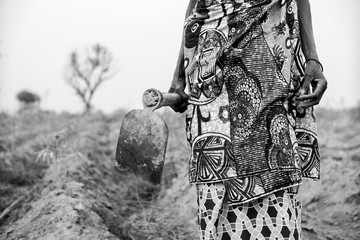 Local Female farmer dressed in african cloths. Black and white. Angola 2019