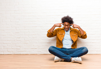 young black man with a serious and concentrated look, brainstorming and thinking about a...