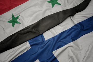 waving colorful flag of finland and national flag of syria.