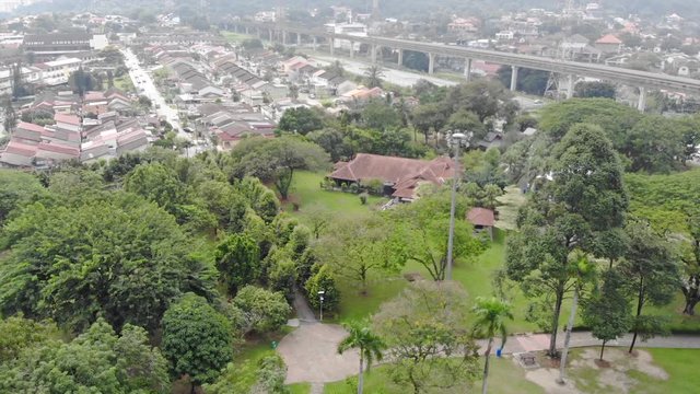 Top Aerial View Of Green Park Full With Tree In And Housing Taman Jaya Park - Dolly Right To Left 