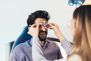Optometrist checking patient eyesight and vision correction