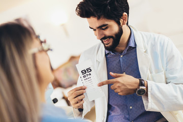 Optometrist checking patient eyesight and vision correction