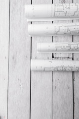 Architect rolls and architectural plan on white table