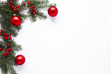 Pine branches and red decorations with copy space