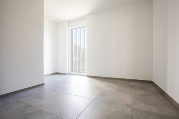 Empty room with white walls and bright window
