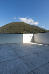 Large terrace with large marble tiles overlooking the Swiss hills in Ticino