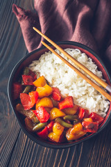 Bowl with white rice and fried vegetables