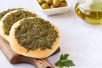 Zaatar manakeesh with olives and olive oil . Close up