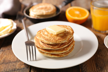 pancake with butter and orange juice