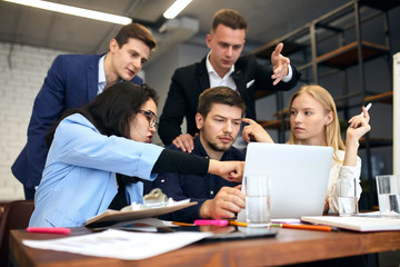 young office workers correcting the document, making presentation, close up photo.