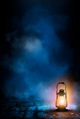 Dark night magic scene with night lanterns. Smoke, magic, magical experience, a fabulous night. Blue neon, moonlight at night. Wet asphalt, reflection.  © MiaStendal