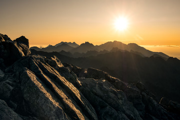 Naklejka premium Sun rising over the beautiful mountains and clouds in High Tatras, Slovakia