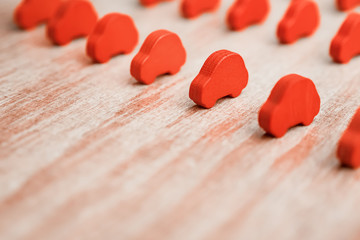Fototapeta premium Objects in the row. Race conceptual. Tendering background. Equal conditions. Equal opportunities. Crowd concept. Service background. Red toy cars on wooden background. Car manufacturing concept