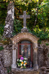 Antique a traditional small stone oratory with a granite cross and a figure of Our Lady from the...