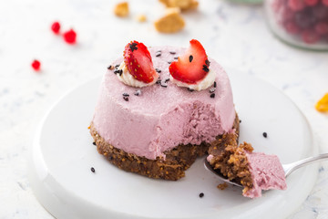 Vegan strawberry dessert. Raw cake with nuts, berries, fruits and seeds. Healthy food
