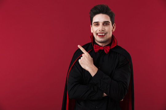 Image of vampire man in black halloween costume pointing finger