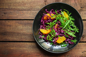 healthy salad orange fillet, red cabbage, arugula (delicious snack, mix leaves lettuce, coleslaw) menu concept. food background. copy space. Top view