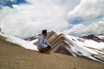 Fototapeta premium Man with panoramic view. Hiking scene in Vinicunca, Cusco region, Peru. Montana of Seven Colors, Rainbow Mountain