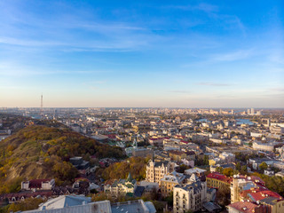 Aerial top view of Kyiv cityscape of Vozdvizhenka and Podol historical districts on sunset from above, city of Kiev, Ukraine