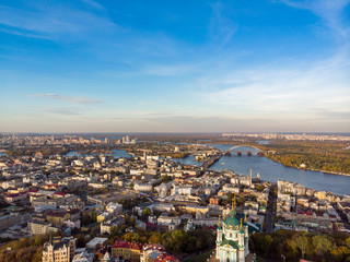 Fototapeta na wymiar Aerial top view of Kyiv cityscape, Dnieper river and Podol historical district skyline from above, Kontraktova square with ferris wheel, city of Kiev, Ukraine
