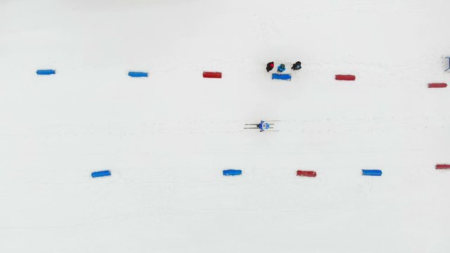 Aerial view from the top, athletes the skiers overcome distance on skis passing by posted route from China and red chips.