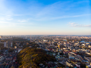Aerial top view of Kyiv cityscape of Vozdvizhenka and Podol historical districts on sunset from above, city of Kiev, Ukraine