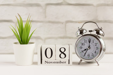 November 8 on the wooden calendar next to the alarm clock, the calendar date of the last autumn month