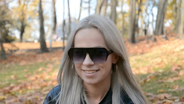 Beautiful blonde girl in sunglasses, portrait and look at the camera
