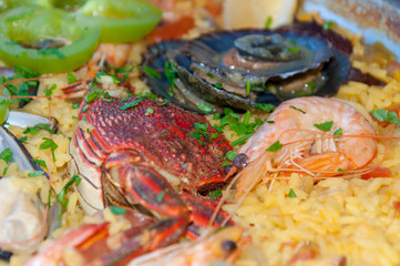Spanish Seafood Paella with Shrimps, Paprika and Lemon. Selective focus.