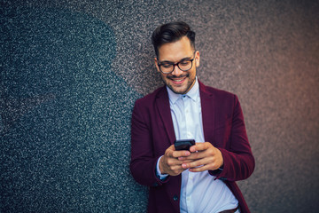 Young and successful businessman using mobile phone