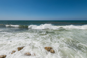 Water flowing and waves in the Mediterranean sea and blue sky at the Tel Aviv port, Israel