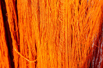 Indigenous Knowledge of thailand. Thai traditional fabric. Natural Volcanic soil dye cotton fabric after dry under sun. Cotton thread dyed orange natural color.