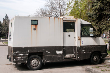 Armored bank truck with broken side glass closeup