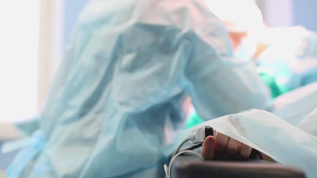 A team of surgeons has a major plan during surgery, a blue light operating room, a rhinoplasty operation to improve the aesthetics of the nose. Medetsina, plastic surgery