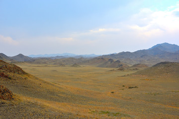 Fototapeta na wymiar Mountains with yellow grass on autumn in Kegen region of Kazakhstan
