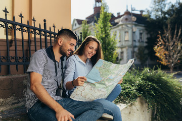 couple tourist in sightseeing in city using paper map