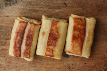 Pancakes with meat on a wooden table 