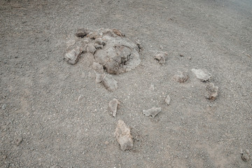 Top of crater Mount Etna volcano, frozen cold lava smokes, thick clouds