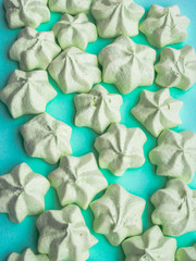 mint green meringues over mint backdrop with copy space