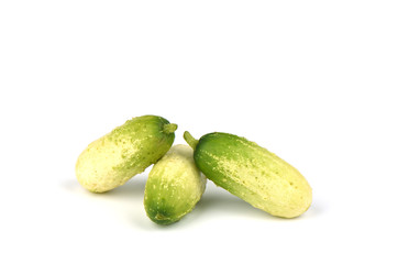 Several organic small cucumbers isolated on white background.